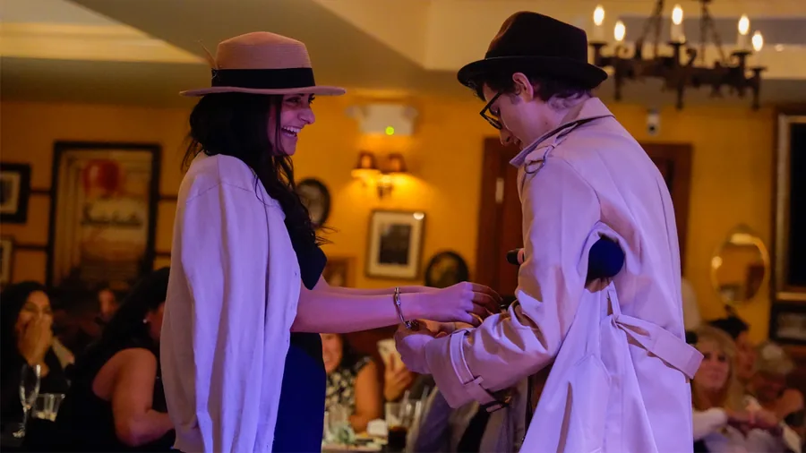 A Murder Mystery Company detective questioning a guest at a Phoenix show